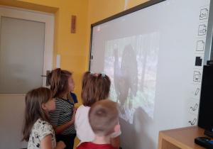 Dzieci przyglądają się z bliska głuszcowi.