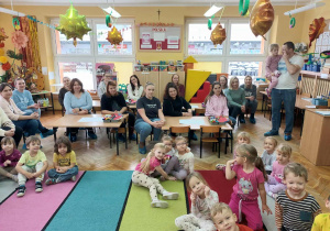 Dzieci i rodzice słuchają opowiadania Pani Renatki.