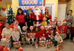 Dzieci z grupy "Żabek" wraz z Mikołajem, elfami, panią Ewą, panią Ewelinką, panią Karinką i panią Dyrektor