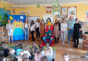 Aktorzy stoją przed publicznością.