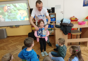 Pan Mariusz przekazuje dla dzieci książeczki: Porozmawiaj ze mną o wodzie i Skąd się wzięła woda w kranie.