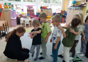 „Krasnoludki” czekają w kolejce na stempelek od prowadzącej.