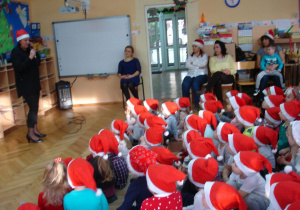 Pani Halinka wita gości i dzieci na spotkaniu z Mikołajem.