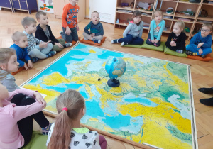 Dzieci oglądają mapę Europy i szukają na niej Włoch.