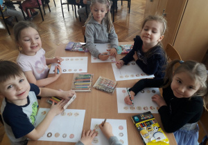 Mateusz, Amelka, Zuzia, Natalka i Ligia trenują oko i rączkę podczas rysowania trasy dzieci do pączków.