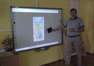 Pan Krzysztof pokazuje dzieciom mapę Niemiec i kraje sąsiadujące z nią.