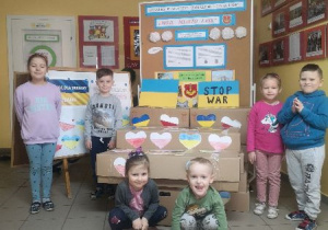 Przedszkolaki prezentują zebrane dary dla Ukrainy.