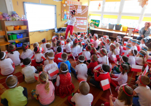 Przedszkolaki oglądają prezentację multimedialną o Polsce.