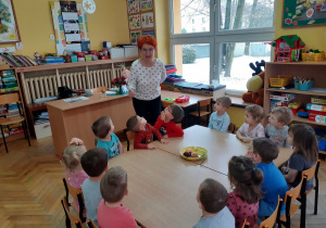 Pani Agnieszka zapoznaje dzieci z cebulą Celiną.