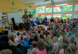 Pan Feliks zapowiada dzieciom rock’n’rollową muzykę.