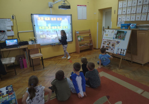 Latika roziązuje zadanie matematyczne na tablicy interaktywnej.